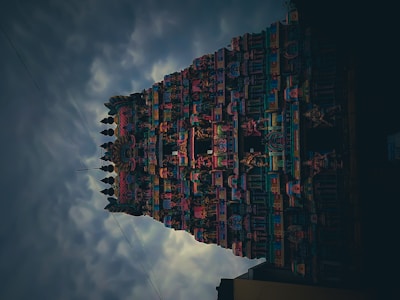 The mysterious faces of Bayon temple under a cloudy sky.