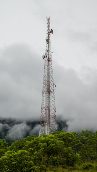 a tall tower sitting on top of a lush green hillside