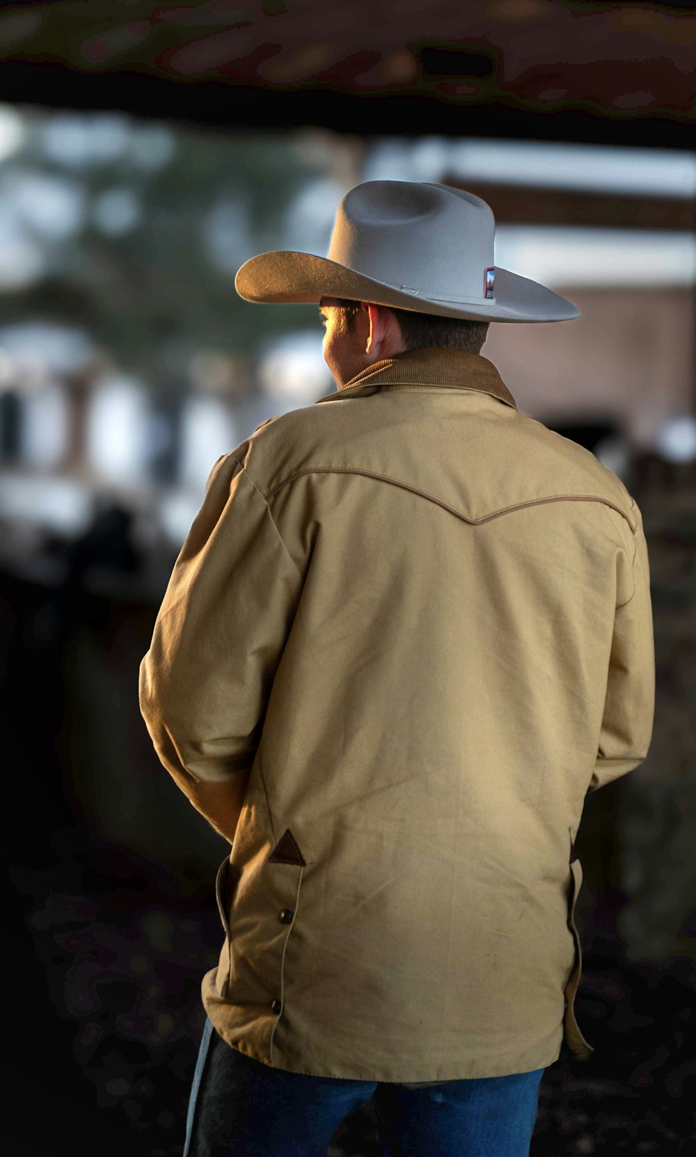 a man in a cowboy hat standing in a room