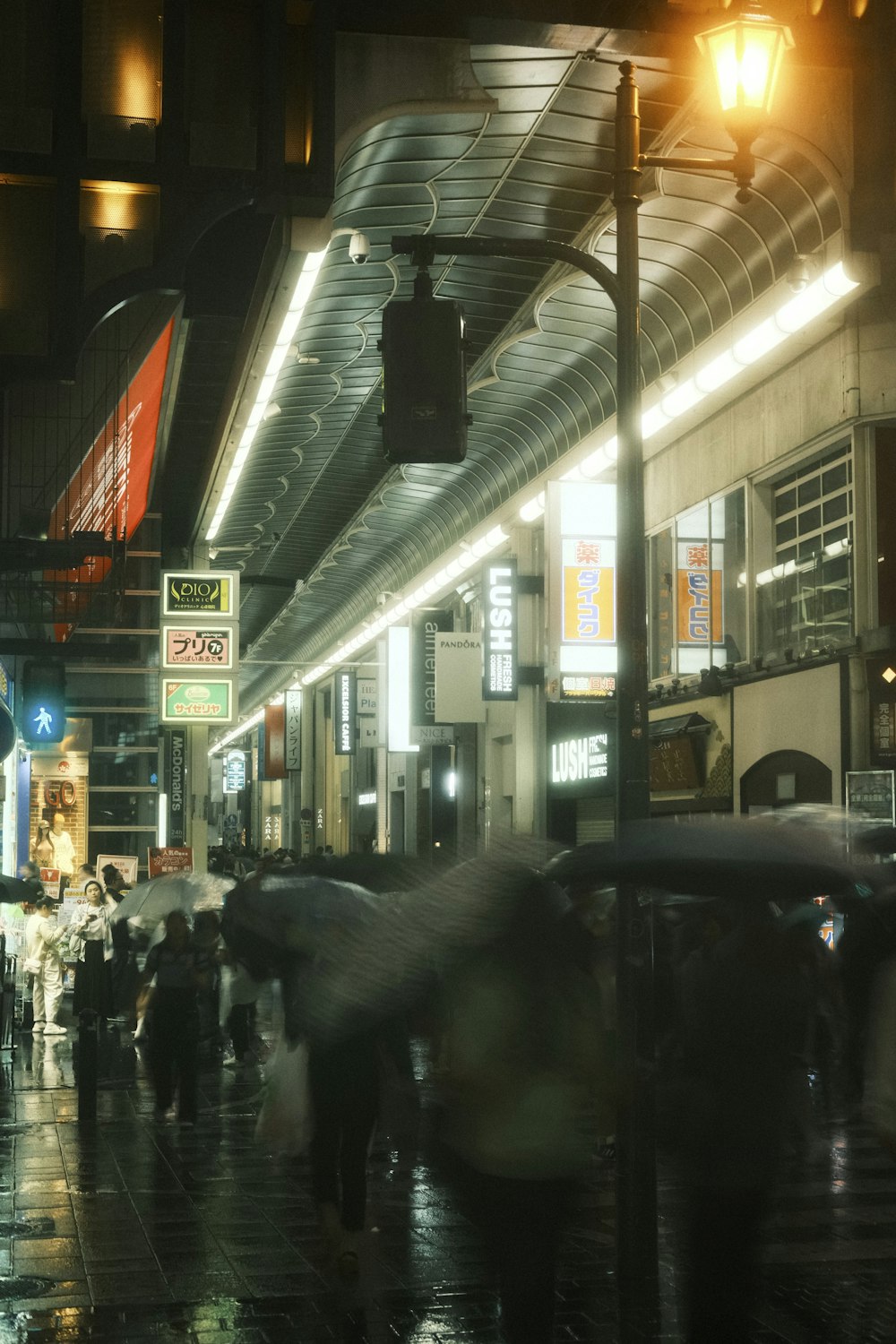 a group of people walking down a street holding umbrellas