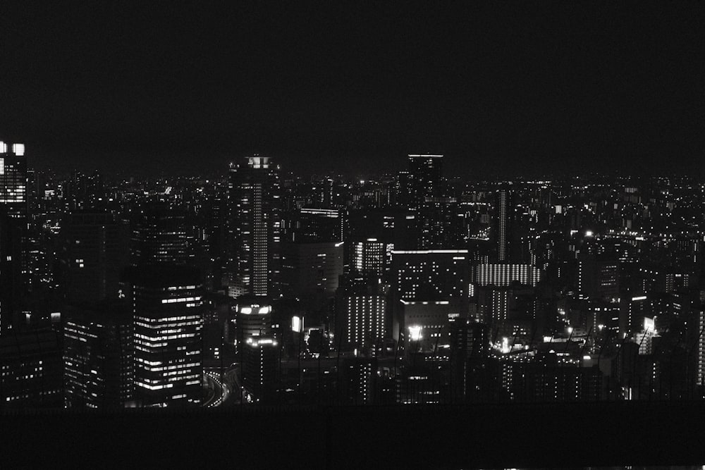 a black and white photo of a city at night