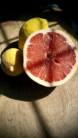 Close-up of vibrant Sicilian citrus fruits arranged on a rustic wooden table