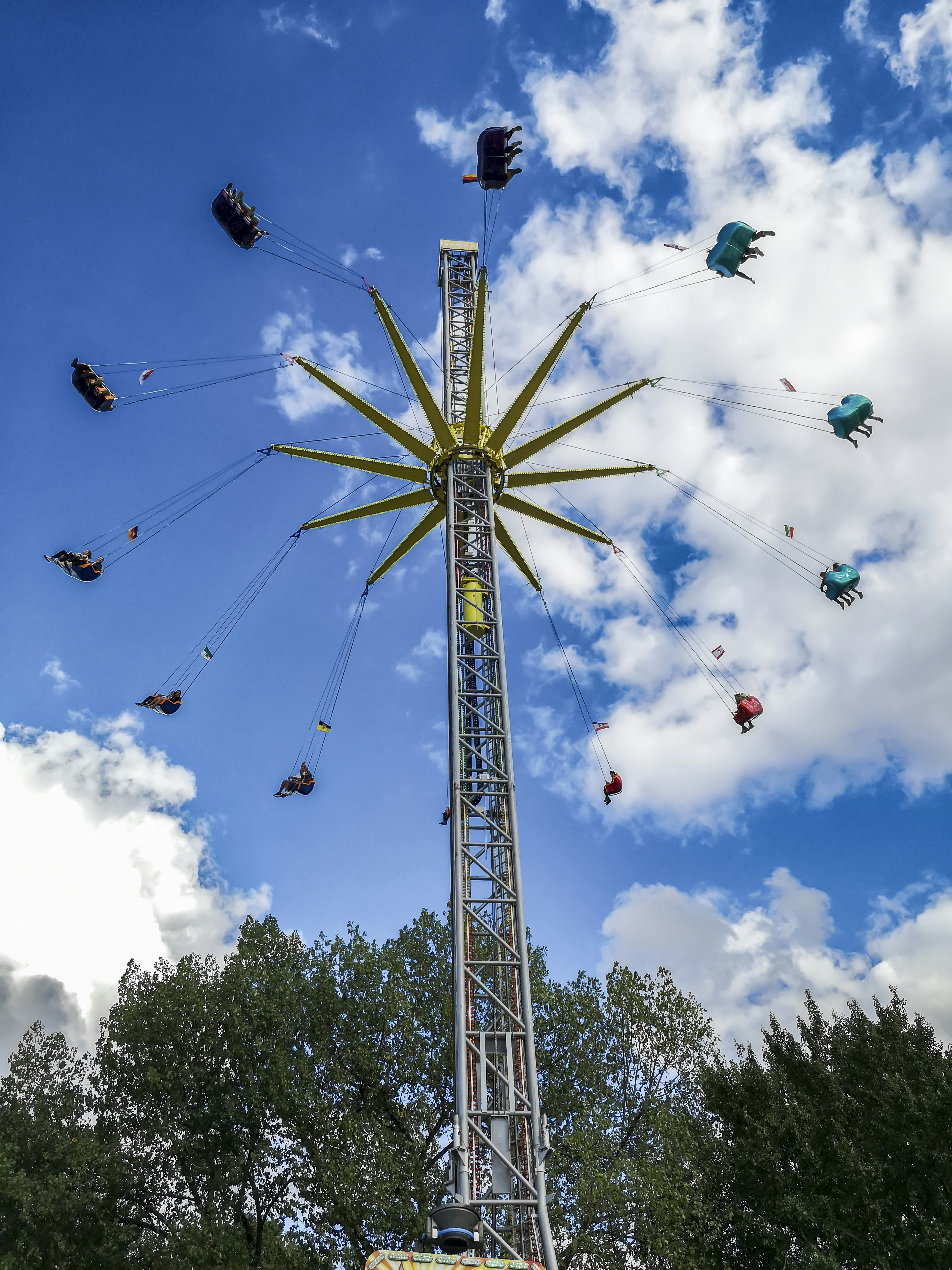 a ferris wheel with people flying around it