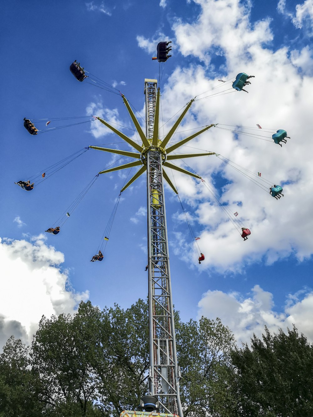 a ferris wheel with people flying around it