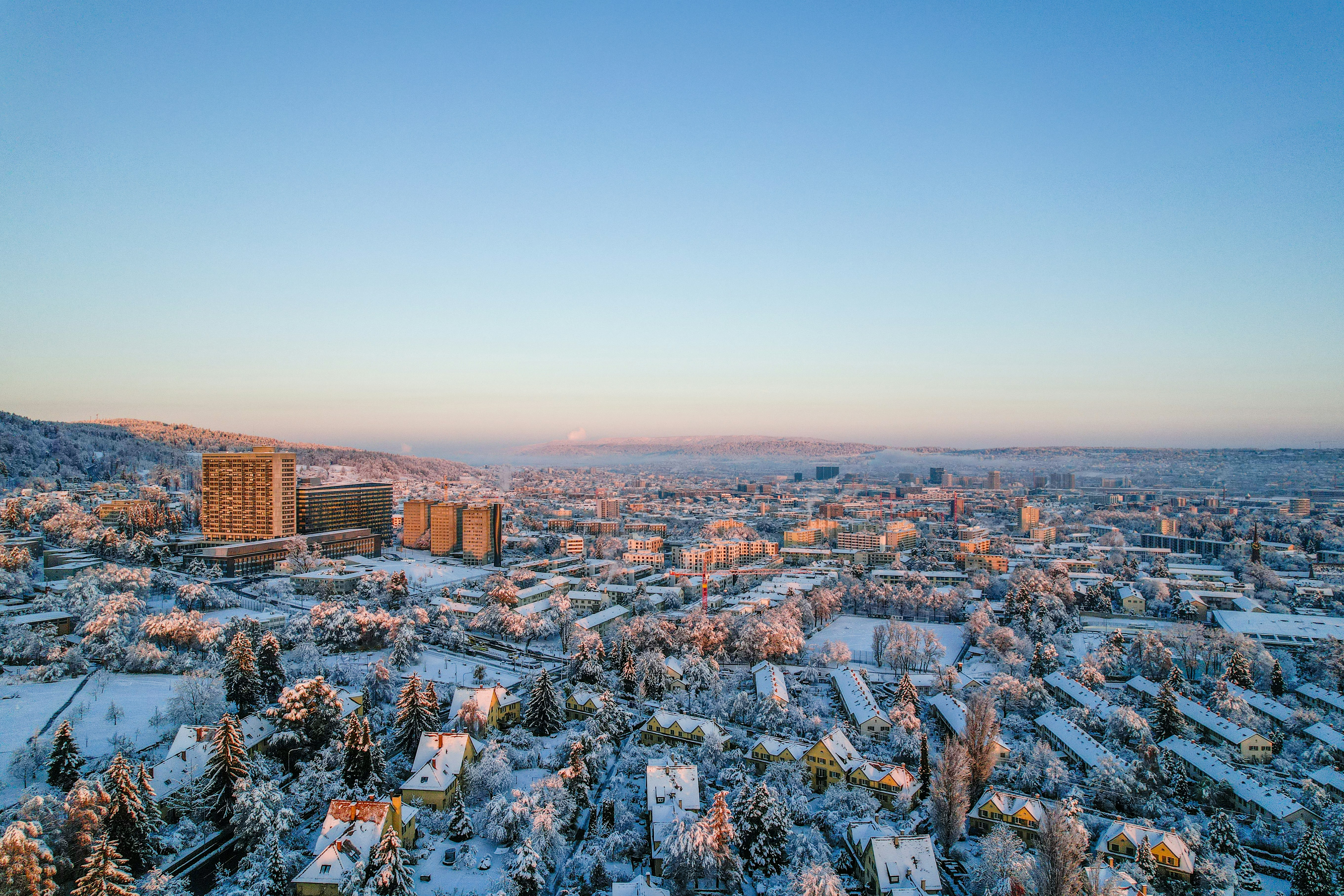 an aerial view of a city in winter, 