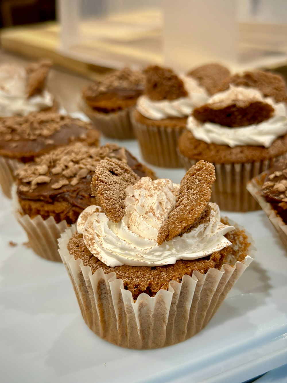 a tray of cupcakes with frosting on them