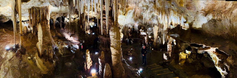 a group of people standing inside of a cave