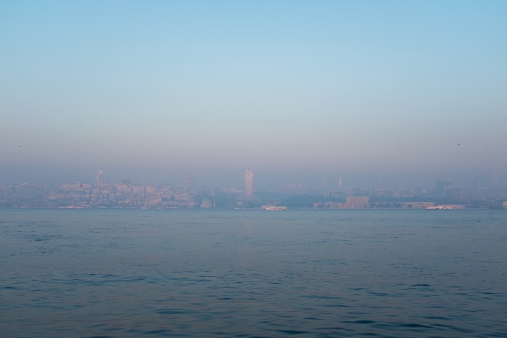 ein großes Gewässer mit einer Stadt im Hintergrund