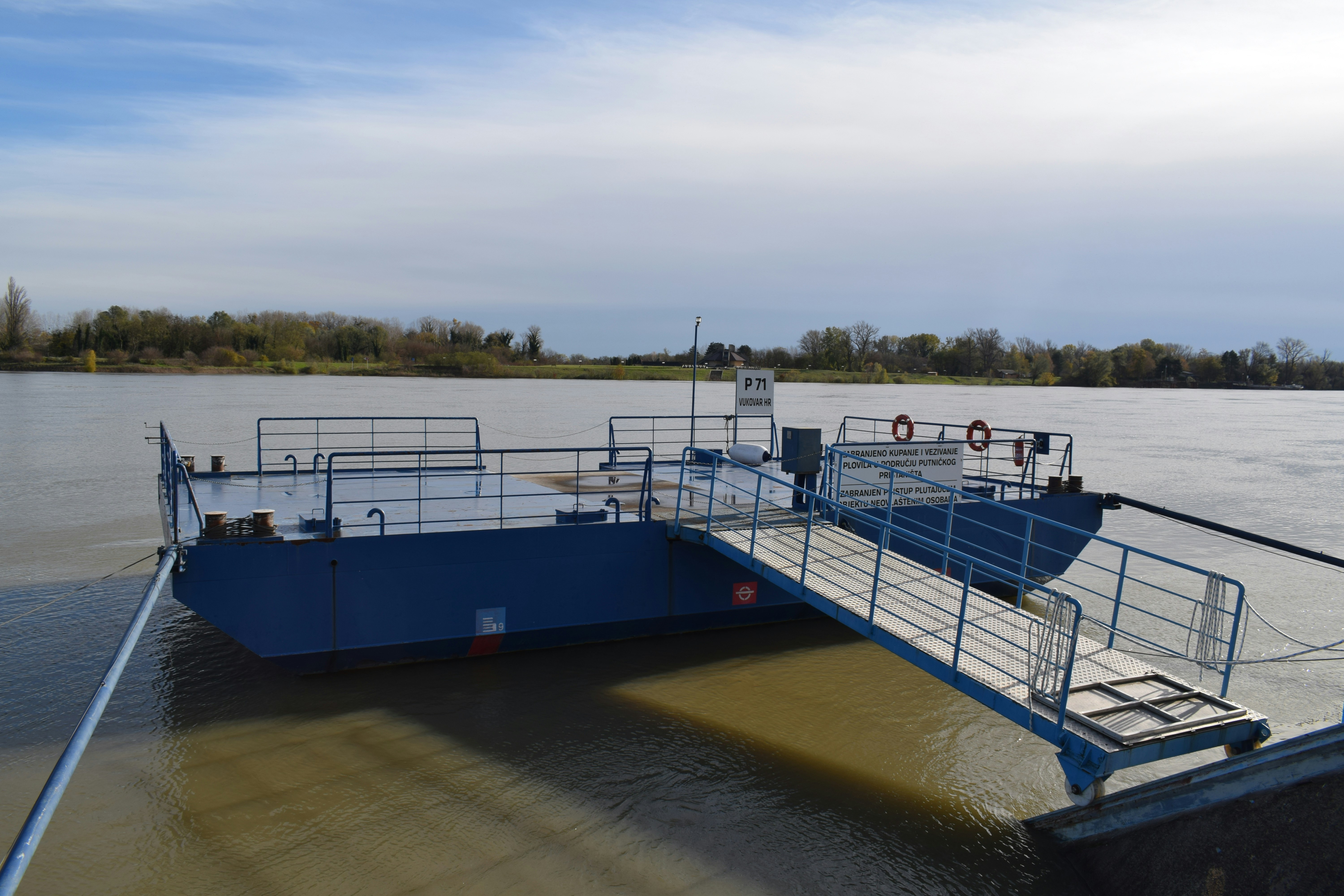 a blue boat sitting on top of a body of water
