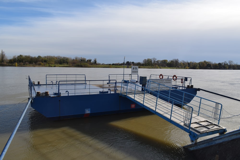 a blue boat sitting on top of a body of water