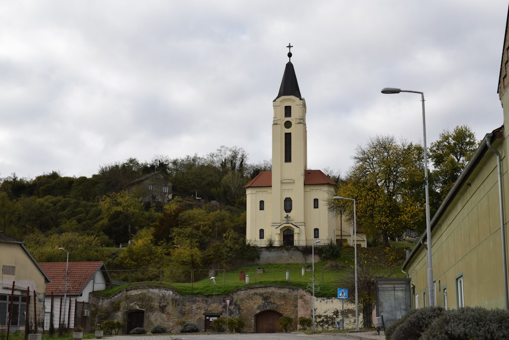 a church on top of a hill with a steeple