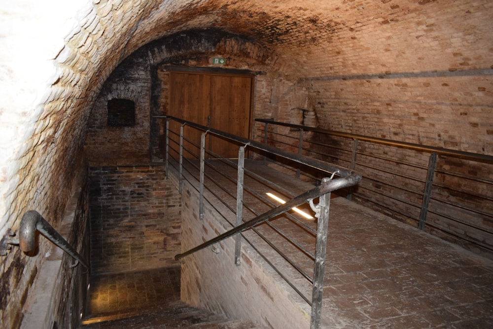 an old brick tunnel with stairs leading up to a door