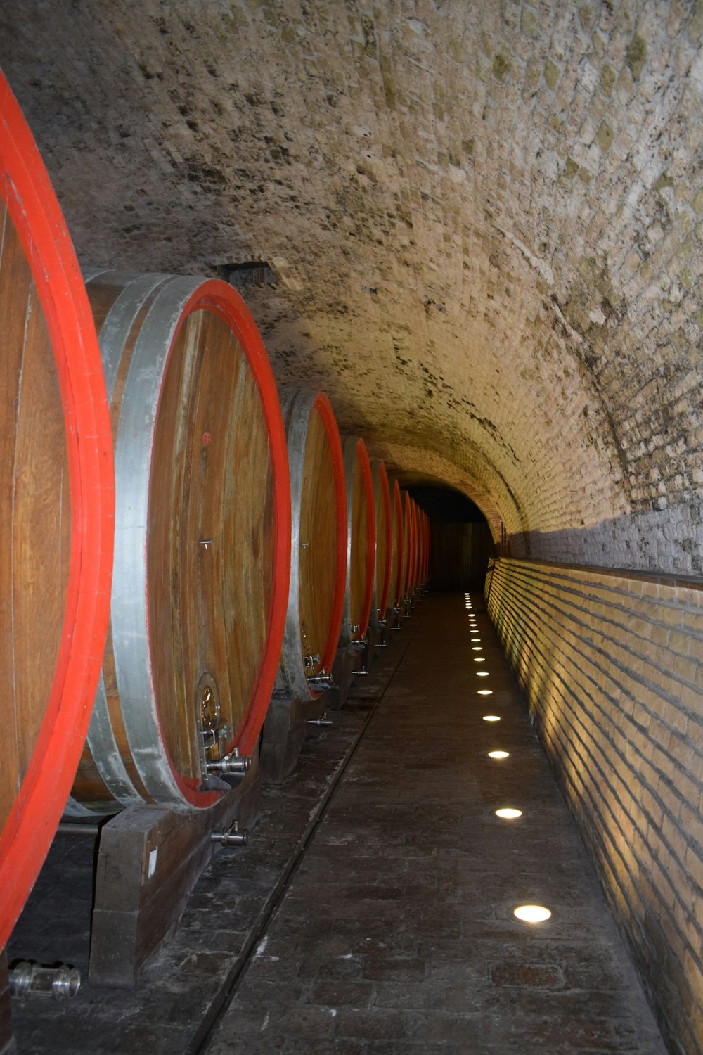 a tunnel with several wine barrels in it