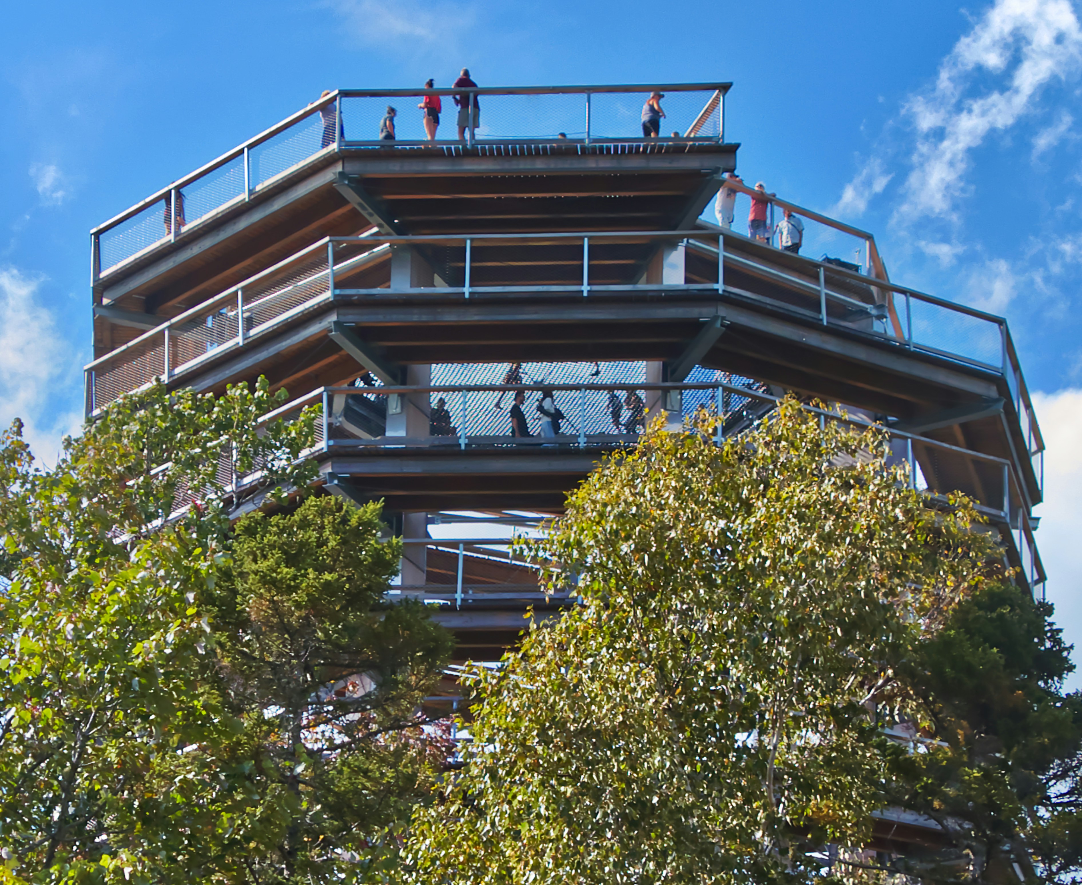 a group of people standing on top of a tall building