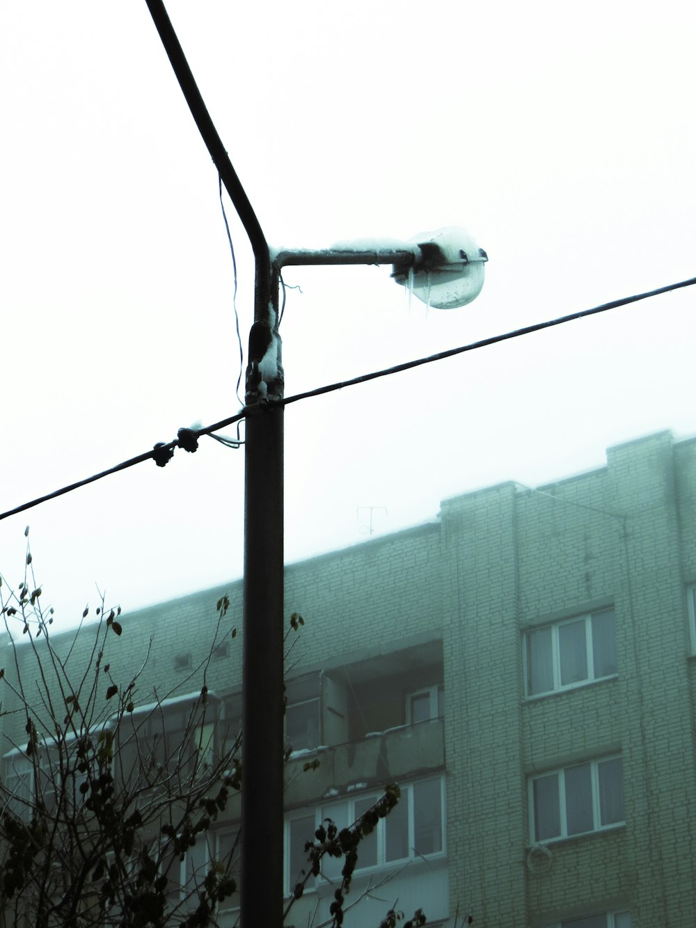 a street light with a building in the background