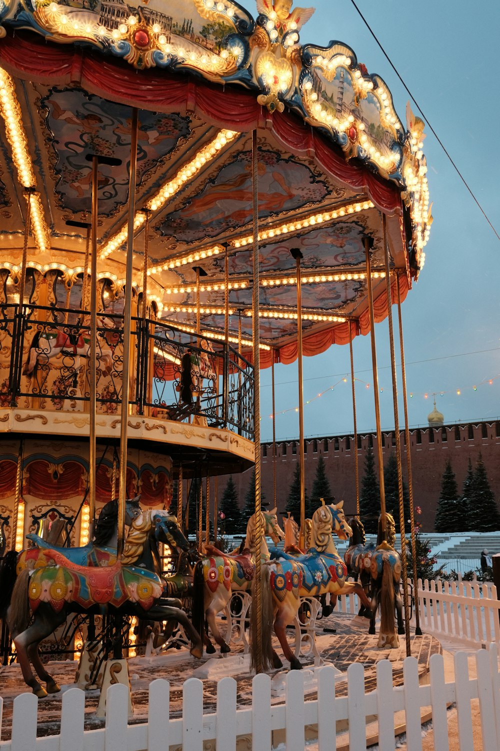 a merry go round with horses and people on it