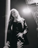A candid street portrait of a person framed by urban shadows.
