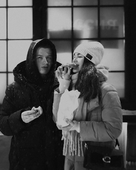 A cozy winter scene featuring diverse individuals in stylish jackets enjoying the snow.