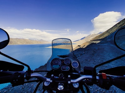a view of a lake from a motorcycle