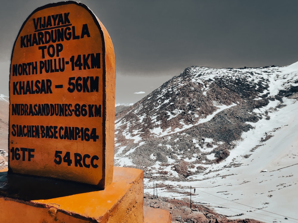 a sign that is on the side of a mountain