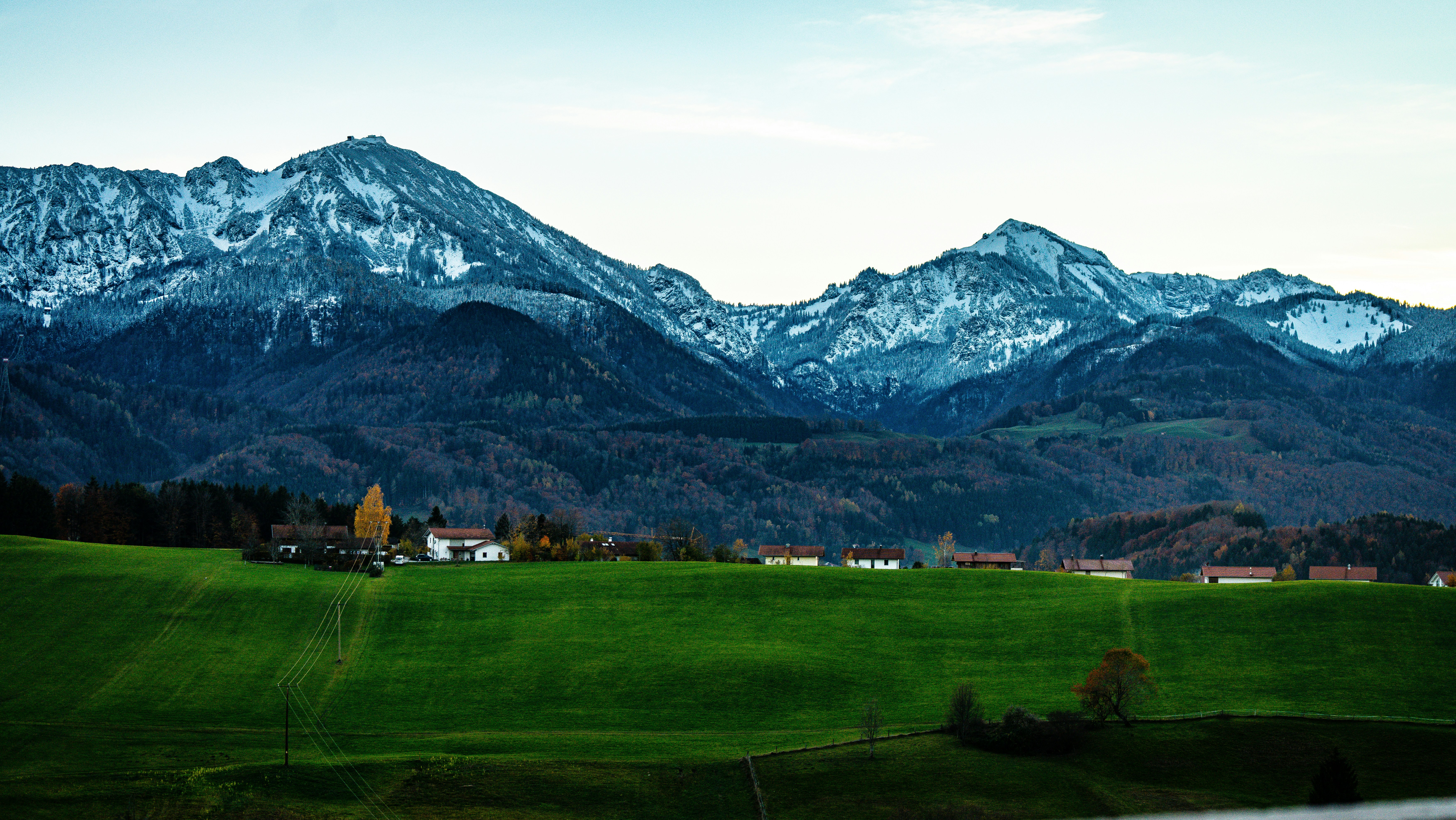 a green field with mountains in the background