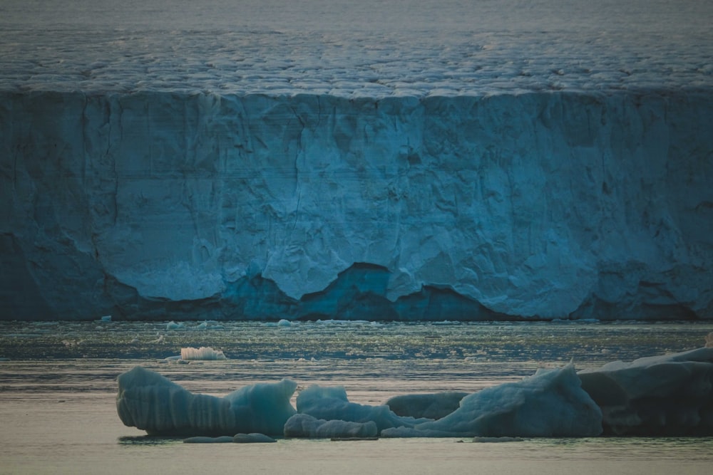 a large iceberg in the middle of a body of water