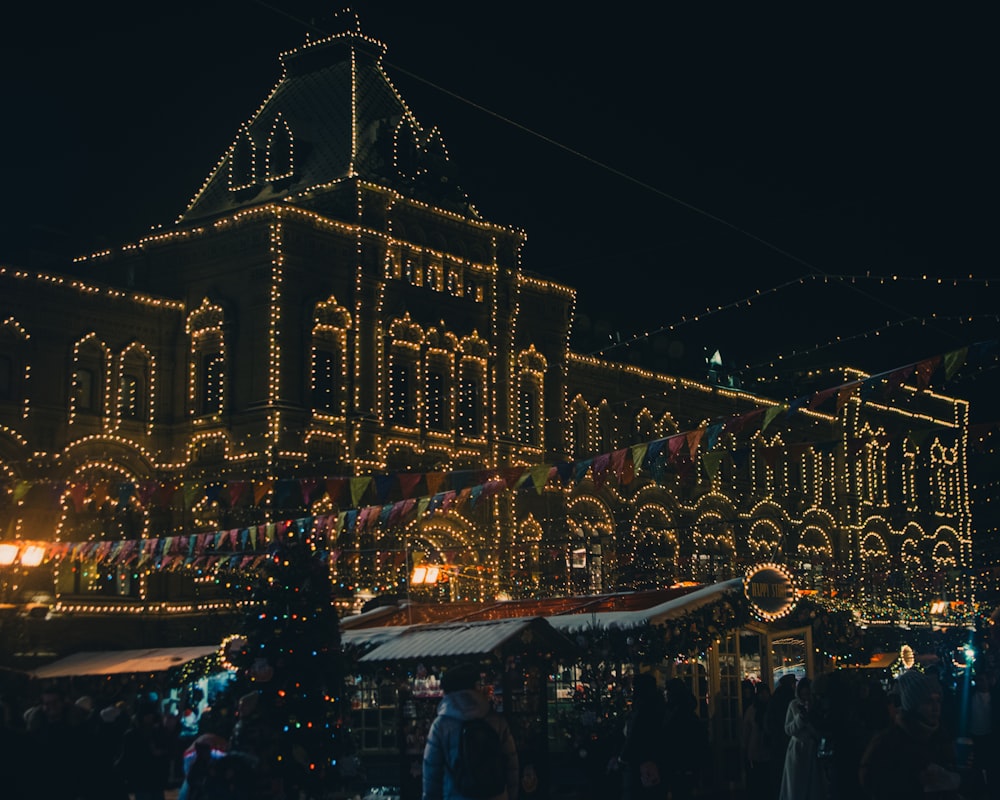 a large building covered in christmas lights at night