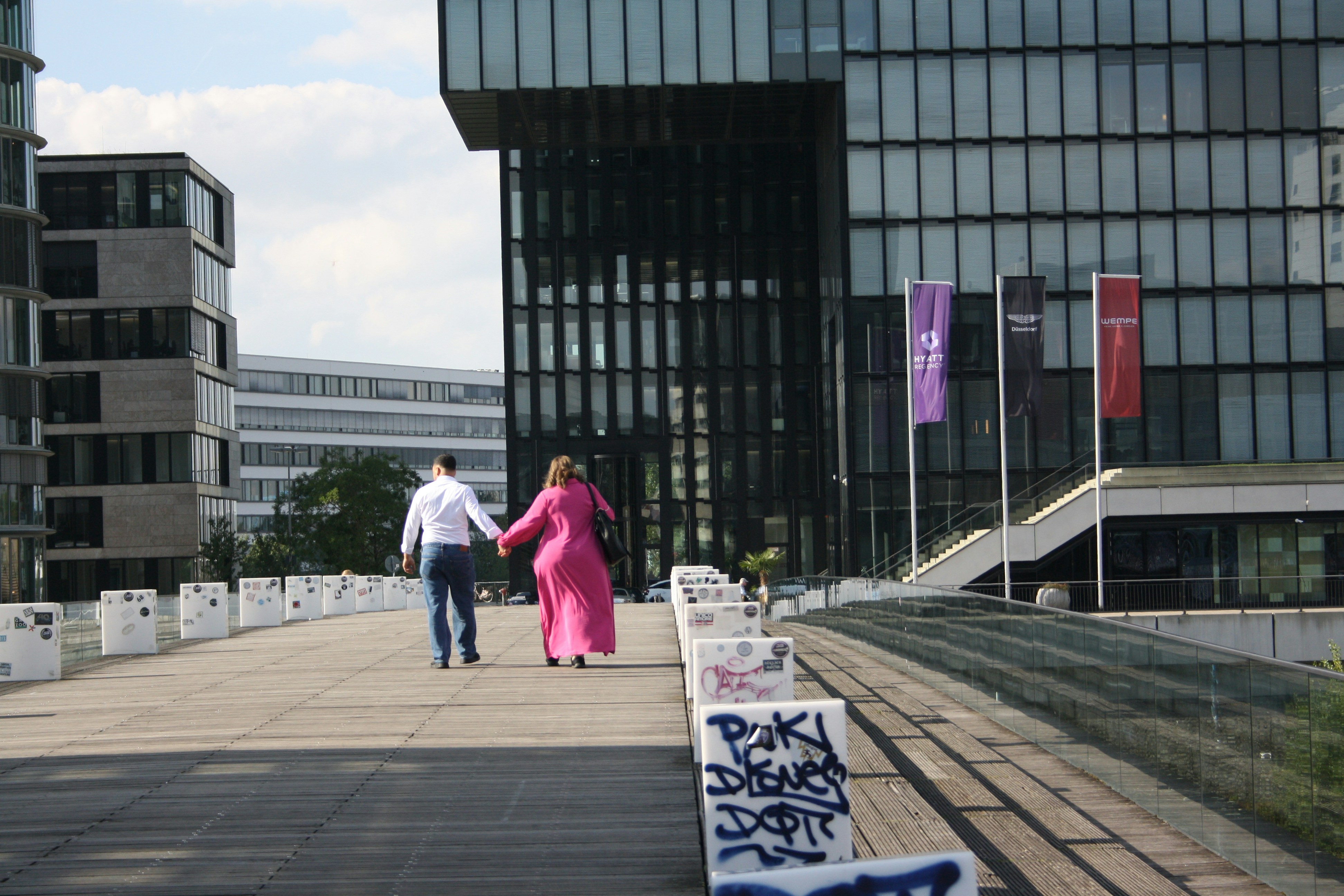 a man and a woman walking down a sidewalk