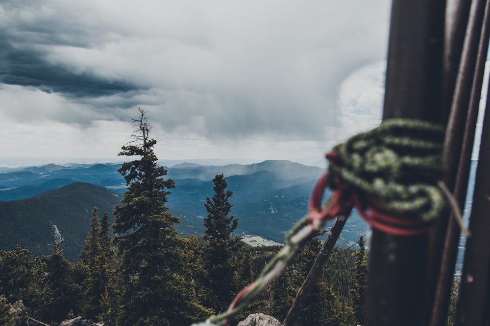 a rope hanging from a wooden post on top of a mountain