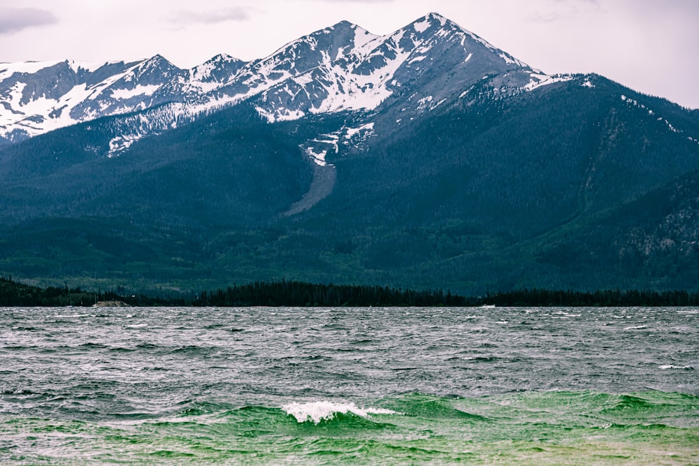 a large body of water with mountains in the background