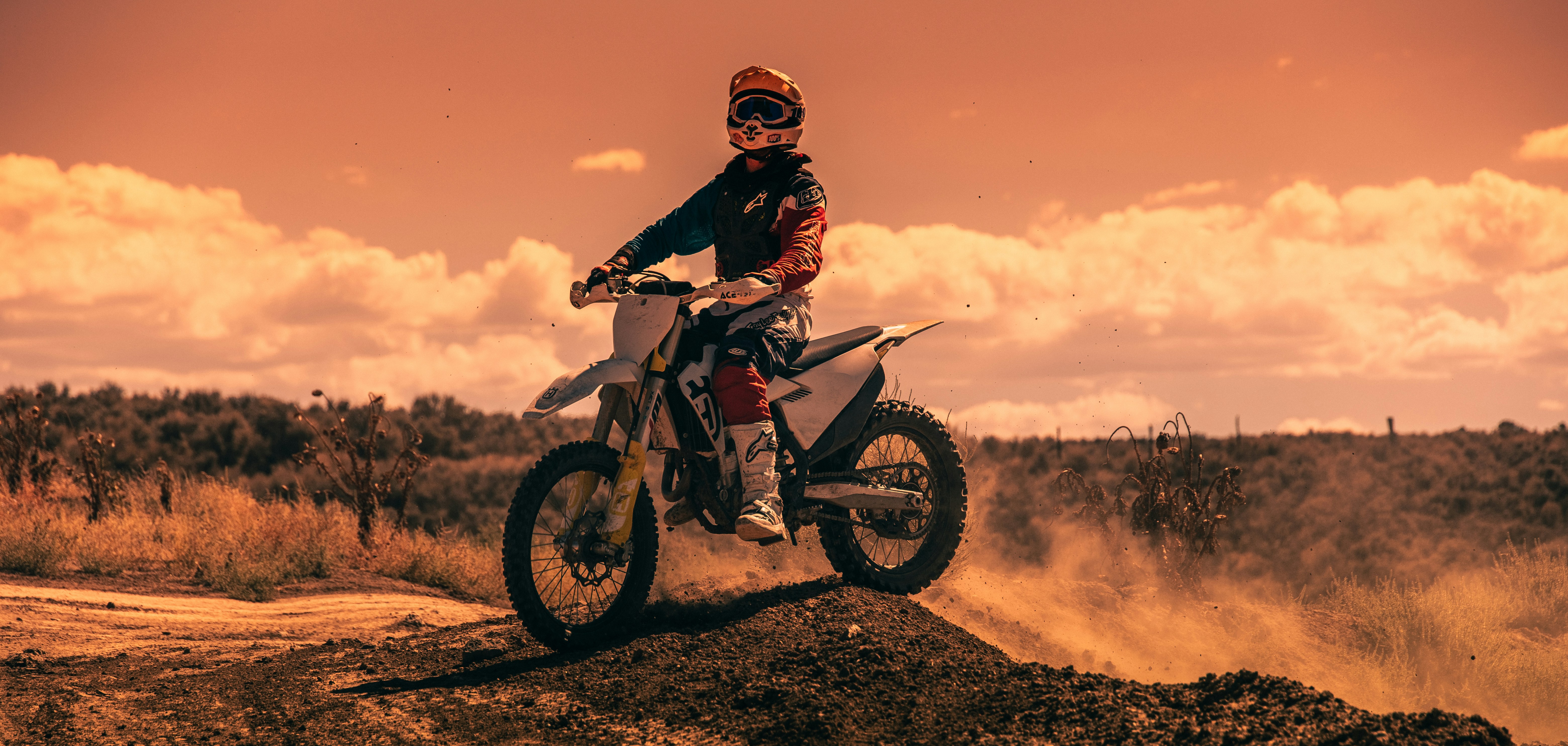 Person riding a dirt bike on a dirt road
