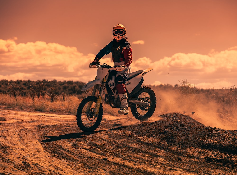 a person riding a dirt bike on a dirt road