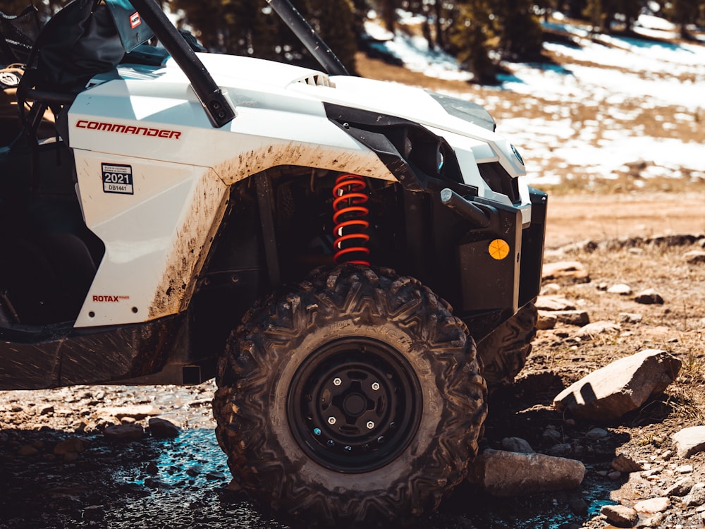 a white four - wheeler parked on the side of the road