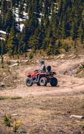 a person riding an atv on a dirt road