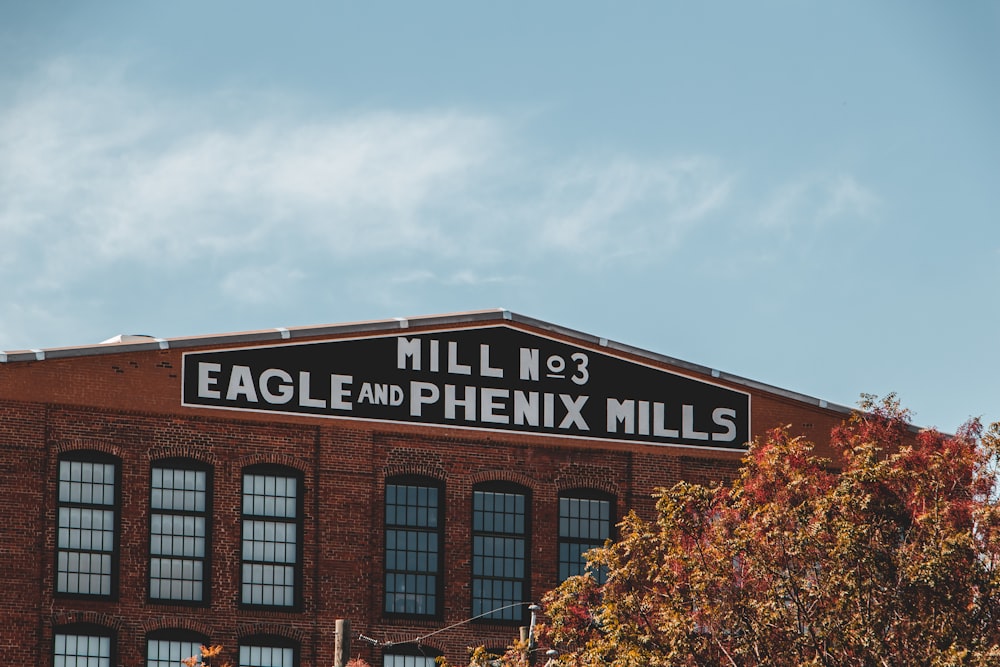 a tall brick building with a sign on top of it