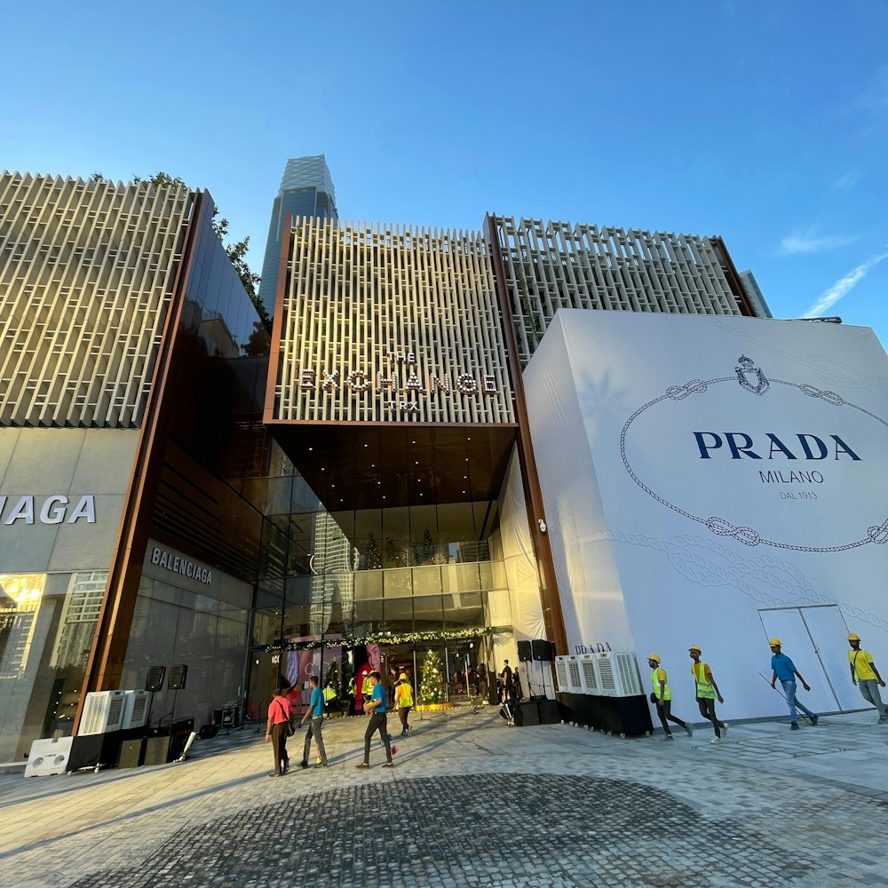 a group of people walking in front of a building