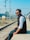 a man sitting on a rail road track