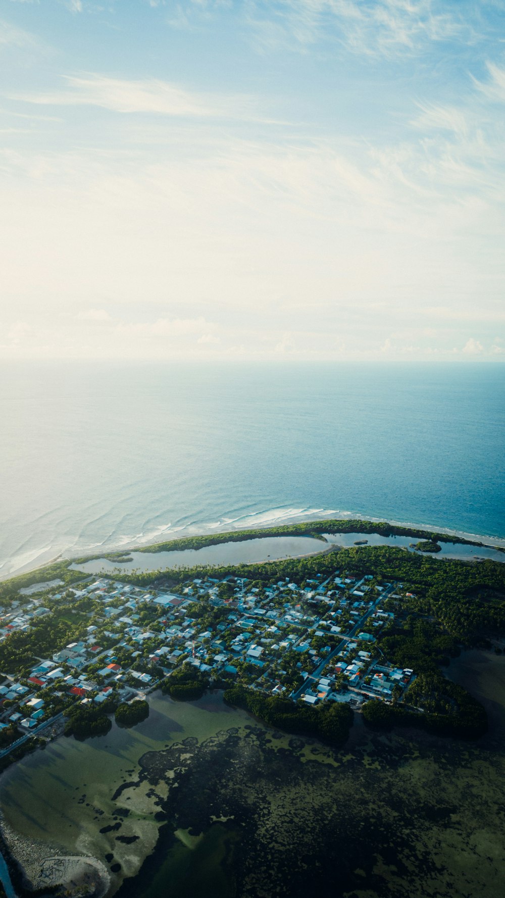 an aerial view of a small town by the ocean