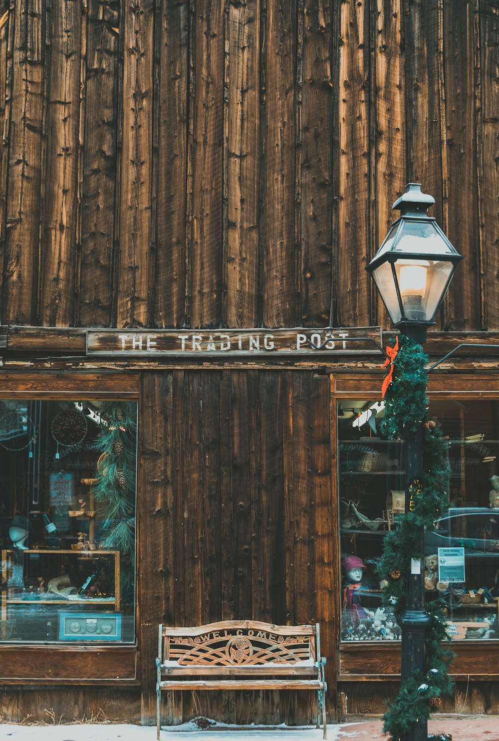 a bench in front of a building with a street light