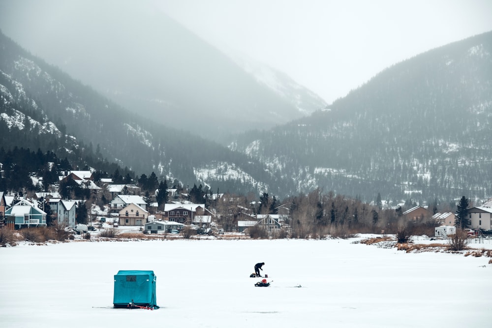 a person on a snowboard in the middle of a lake