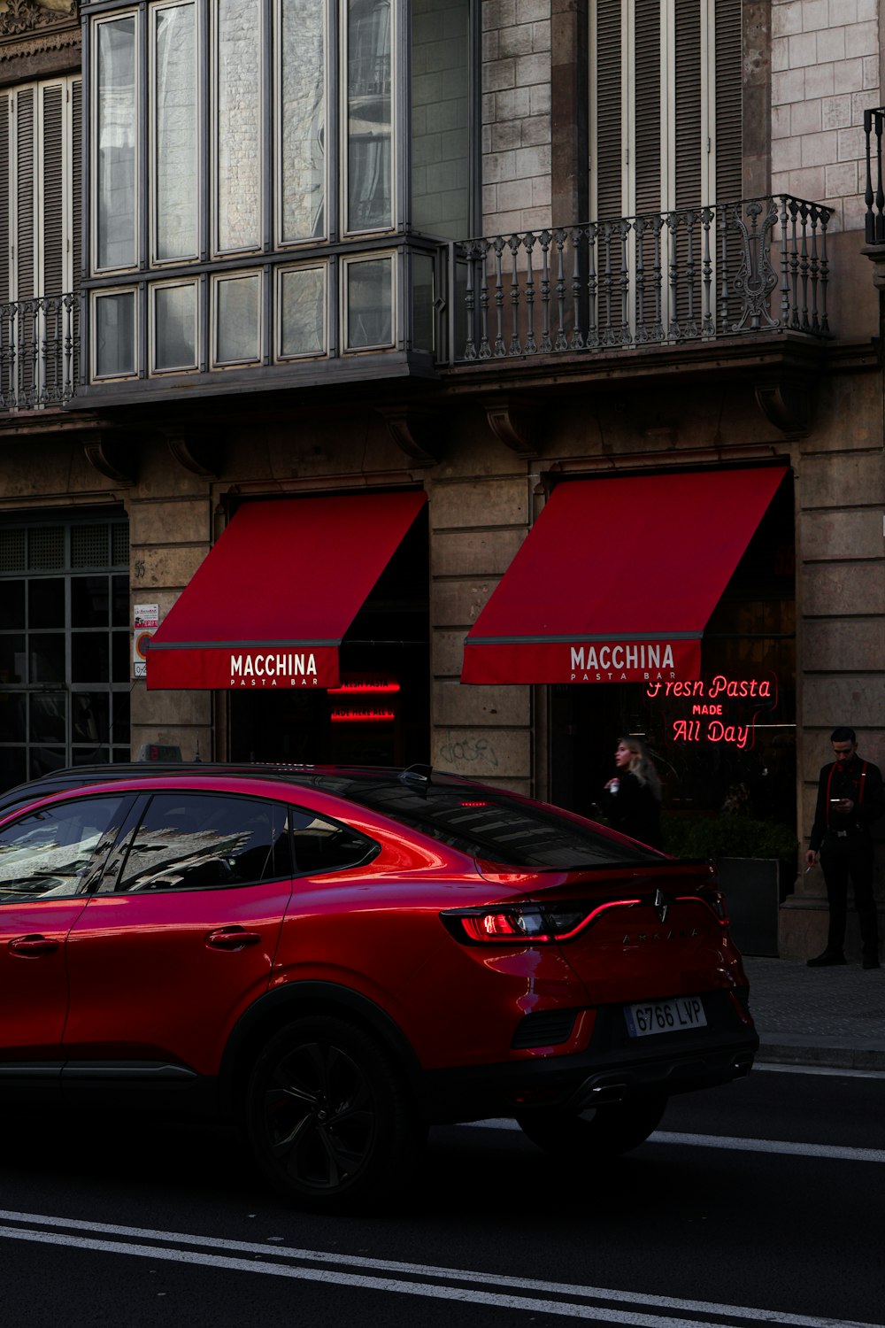 a red car parked on the side of the road