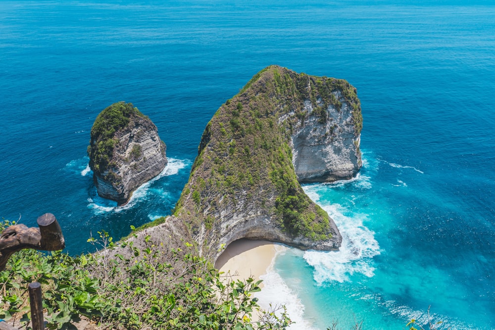 two large rocks sticking out of the ocean