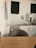 Side-by-side before and after photos of a break room/kitchen area after cleaning.