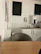 Side-by-side before and after photos of a break room/kitchen area after cleaning.