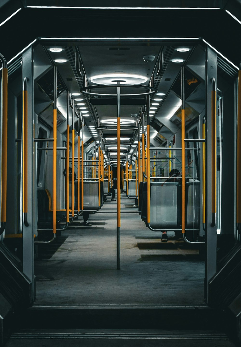 an empty subway car with yellow and black accents