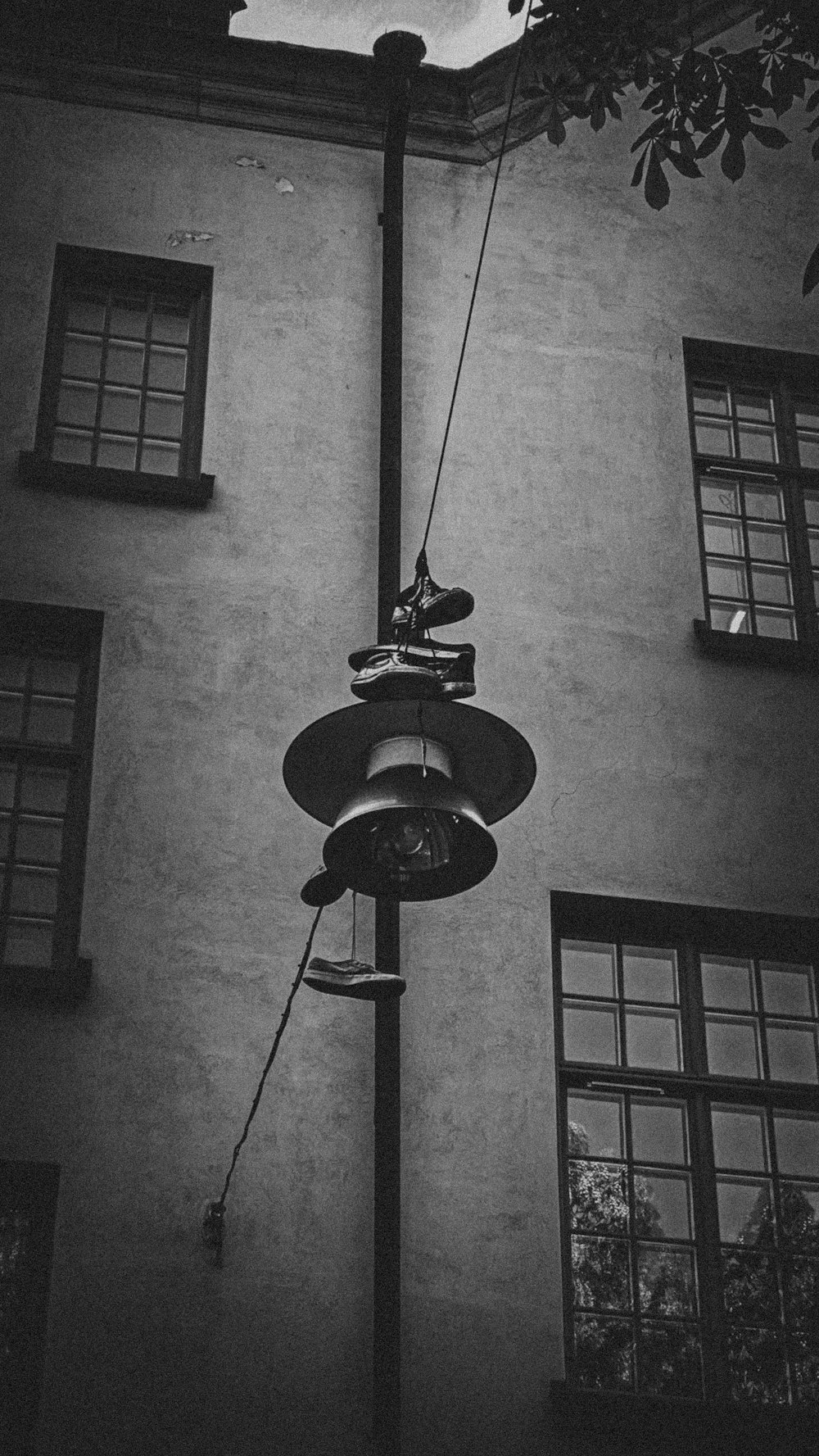 a black and white photo of a street light in front of a building