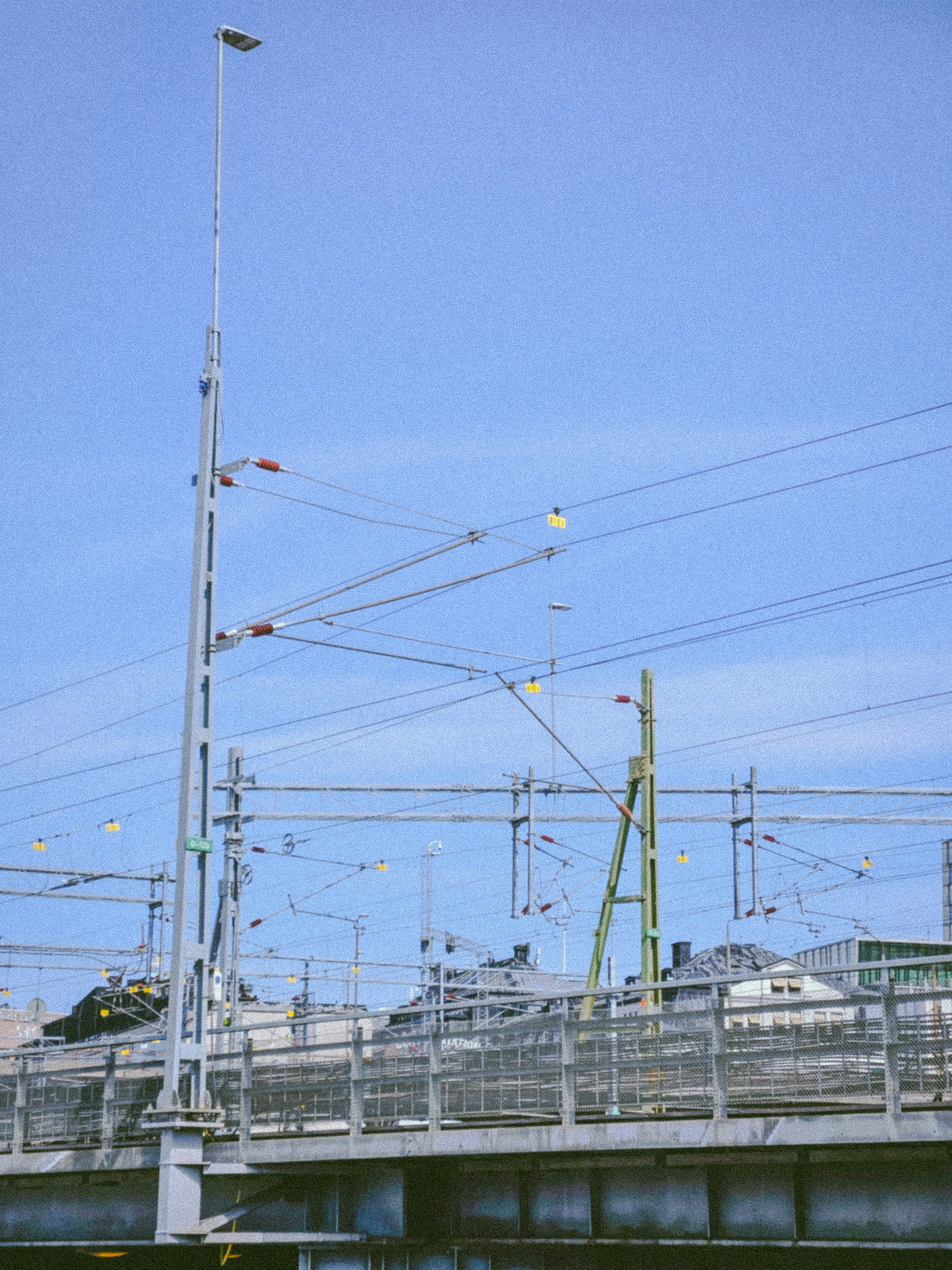 a train traveling over a bridge next to a tall building