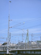 a train traveling over a bridge next to a tall building