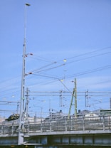 a train traveling over a bridge next to a tall building