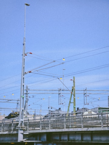 a train traveling over a bridge next to a tall building